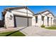 Single-story home featuring a brick driveway and attached two-car garage at 2260 E Warbler Rd, Gilbert, AZ 85297