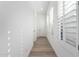 Bright hallway with wood-look tile flooring, white walls, and natural light from window at 2260 E Warbler Rd, Gilbert, AZ 85297