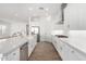 Spacious kitchen with large island, stainless steel appliances and sleek white cabinets at 2260 E Warbler Rd, Gilbert, AZ 85297