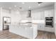 Beautiful white kitchen with stainless steel appliances, quartz countertops, and large island at 2260 E Warbler Rd, Gilbert, AZ 85297