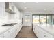 Well-lit kitchen with stainless steel appliances, white cabinets and subway tile backsplash at 2260 E Warbler Rd, Gilbert, AZ 85297
