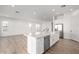 Spacious open-concept kitchen with large island, white cabinets and stainless steel appliances at 2260 E Warbler Rd, Gilbert, AZ 85297