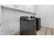 Spacious laundry room with washer and dryer, and built-in cabinets for easy storage at 2260 E Warbler Rd, Gilbert, AZ 85297