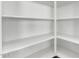 White shelving provides ample storage in this well-organized pantry at 2260 E Warbler Rd, Gilbert, AZ 85297