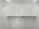 Empty walk-in closet featuring white walls and built-in shelving rods at 2260 E Warbler Rd, Gilbert, AZ 85297