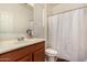 Clean bathroom with a sink, toilet, and shower curtain at 2324 W Melody Dr, Phoenix, AZ 85041