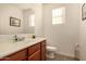 Charming half bathroom featuring wooden cabinets and neutral decor at 2324 W Melody Dr, Phoenix, AZ 85041