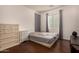 Cozy bedroom with hardwood floors, a window, and simple decor at 2324 W Melody Dr, Phoenix, AZ 85041