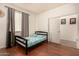 A bright bedroom includes wood flooring, a twin bed, and natural lighting at 2324 W Melody Dr, Phoenix, AZ 85041