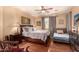 Spacious bedroom with hardwood floors, ceiling fan and natural light at 2324 W Melody Dr, Phoenix, AZ 85041