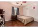Bedroom featuring a window, hardwood floors, and a ceiling fan at 2324 W Melody Dr, Phoenix, AZ 85041