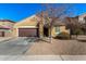 Inviting single story home with a well-manicured front yard, desert landscaping, and a two-car garage at 2324 W Melody Dr, Phoenix, AZ 85041