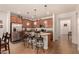 The kitchen features an island with barstool seating, granite countertops, and stainless steel appliances at 2324 W Melody Dr, Phoenix, AZ 85041