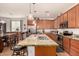 Kitchen island features granite countertops, stainless appliances, and wood cabinets with seating at 2324 W Melody Dr, Phoenix, AZ 85041