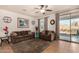 Comfortable living room with neutral tones, tile floors, and a sliding glass door to the patio at 2324 W Melody Dr, Phoenix, AZ 85041