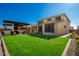Expansive backyard featuring lush grass, a covered patio, and space for outdoor enjoyment at 24578 W Concorda Dr, Buckeye, AZ 85326