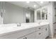 Bright bathroom with double sinks, a large mirror, and ample cabinet storage space at 24578 W Concorda Dr, Buckeye, AZ 85326