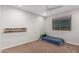 Minimalist bedroom with carpet, window, and car decor shelf offering cozy space at 24578 W Concorda Dr, Buckeye, AZ 85326