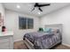 Cozy bedroom with neutral colors, a ceiling fan, and a large window at 24578 W Concorda Dr, Buckeye, AZ 85326
