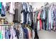 Walk-in closet filled with clothing hung on rods and organized on shelves at 24578 W Concorda Dr, Buckeye, AZ 85326