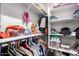 Walk-in closet offers organized storage with shelves and hanging space for clothes and accessories at 24578 W Concorda Dr, Buckeye, AZ 85326
