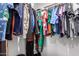 Well-organized closet with a variety of clothing items hanging on rods at 24578 W Concorda Dr, Buckeye, AZ 85326