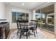 Bright dining area with natural light, wood floors, a round dining table, and a view of the backyard at 24578 W Concorda Dr, Buckeye, AZ 85326