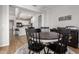 Casual dining area with a round table and chairs, connecting to a modern kitchen and living space at 24578 W Concorda Dr, Buckeye, AZ 85326