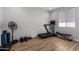 Dedicated exercise room with hardwood floors, weights, a fan, and a treadmill at 24578 W Concorda Dr, Buckeye, AZ 85326