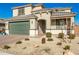 Two-story home boasting a green garage door, neutral stucco and decorative desert rock landscaping at 24578 W Concorda Dr, Buckeye, AZ 85326
