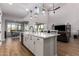 Bright, open kitchen with island, stainless steel appliances, and views to dining and living areas at 24578 W Concorda Dr, Buckeye, AZ 85326