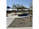 Shaded park pavilion with picnic table and seating area, surrounded by desert landscaping at 24578 W Concorda Dr, Buckeye, AZ 85326