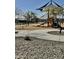 Community playground with slides and play structures surrounded by desert landscaping at 24578 W Concorda Dr, Buckeye, AZ 85326