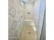 Walk-in shower featuring decorative tiles, a built-in bench, and a handheld shower head at 24578 W Concorda Dr, Buckeye, AZ 85326
