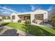 Beautiful backyard featuring artificial grass, desert landscaping, an outdoor kitchen, and a covered patio at 25925 W Mcrae Dr, Buckeye, AZ 85396