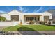 Well-maintained backyard with artificial grass, desert landscaping, an outdoor kitchen, and a covered patio at 25925 W Mcrae Dr, Buckeye, AZ 85396