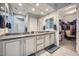 Large bathroom features dual sinks, granite counters, and a doorway to the walk-in closet at 25925 W Mcrae Dr, Buckeye, AZ 85396