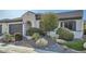 Charming home featuring desert landscaping, including rocks and cacti, plus a gray garage door at 25925 W Mcrae Dr, Buckeye, AZ 85396