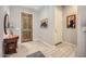 Foyer featuring tiled floors, wood door and side table at 25925 W Mcrae Dr, Buckeye, AZ 85396