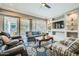 Cozy living room with built-in shelves, television, and sliding glass doors at 25925 W Mcrae Dr, Buckeye, AZ 85396