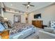 Beautifully decorated bedroom with a sitting area, ceiling fan, and spacious layout at 25925 W Mcrae Dr, Buckeye, AZ 85396