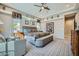 Large bedroom with a tray ceiling, sitting area, and elegant decor at 25925 W Mcrae Dr, Buckeye, AZ 85396