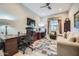 Home office features ample desk space, a comfortable sofa, and neutral wall colors at 25925 W Mcrae Dr, Buckeye, AZ 85396