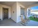 Inviting porch with rocking chairs and a view of the artificial turf area at 25925 W Mcrae Dr, Buckeye, AZ 85396