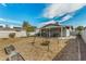 Spacious backyard with a covered patio, swing set, and a beautiful sky, perfect for outdoor activities at 2618 N 15Th St, Phoenix, AZ 85006