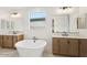 Bright bathroom with soaking tub, double vanity, and sleek modern fixtures at 26361 N 76Th Dr, Peoria, AZ 85383