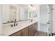 Modern bathroom showcasing dual sinks, wood cabinets, and a large mirror at 26361 N 76Th Dr, Peoria, AZ 85383