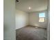 Cozy bedroom with neutral carpet, a window offering natural light, and fresh, minimalist design at 26361 N 76Th Dr, Peoria, AZ 85383