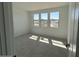 A bright bedroom featuring three large windows and neutral carpet, ready for personalization and comfort at 26361 N 76Th Dr, Peoria, AZ 85383