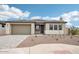 Charming single-story home with a well-manicured desert landscape and paved driveway leading to the two-car garage at 26361 N 76Th Dr, Peoria, AZ 85383